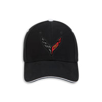 A black baseball cap featuring an embroidered Corvette C8 logo on the front panel, with a white top button and white piping along the edge of the curved brim.